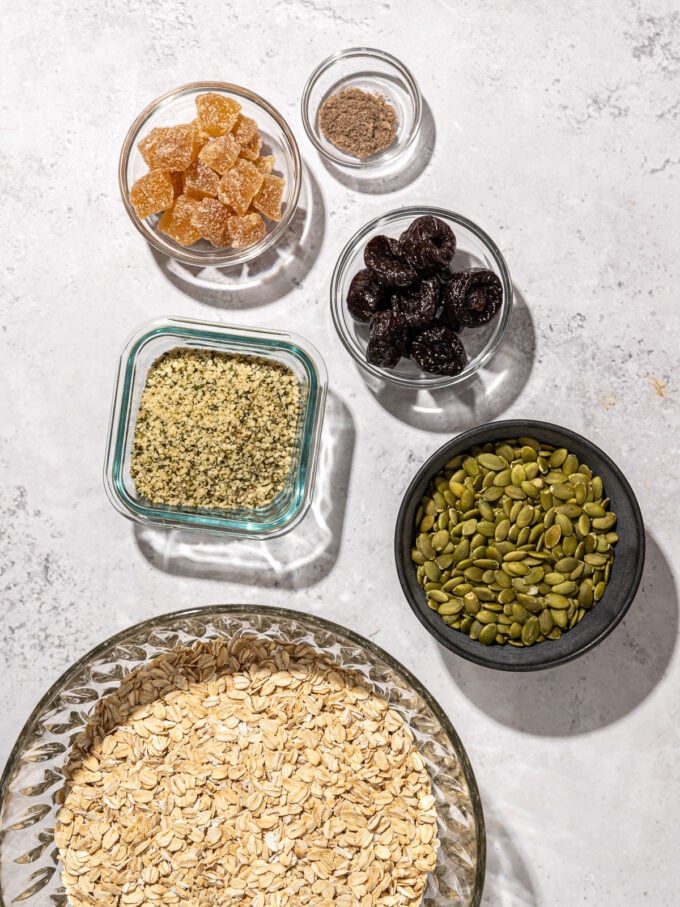 oats, pumpkin seeds and hemp hearts in bowls