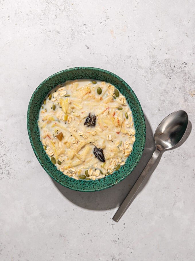 raw Muesli in bowl with spoon 