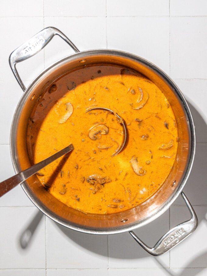 mushroom lentil stew in pot with ladle