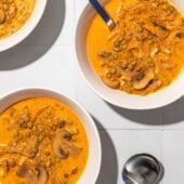 mushroom and lentil stew in white bowls with spoons