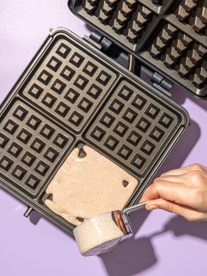 Pouring batter onto waffle iron