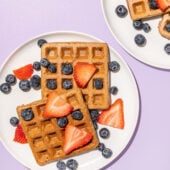 waffles with berries on white plates