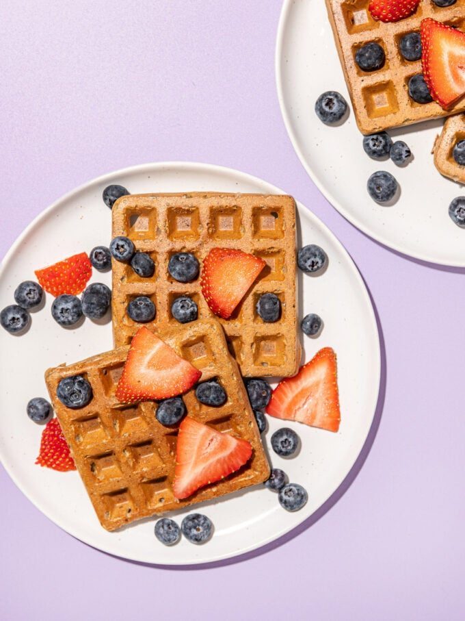 waffles with berries on white plates