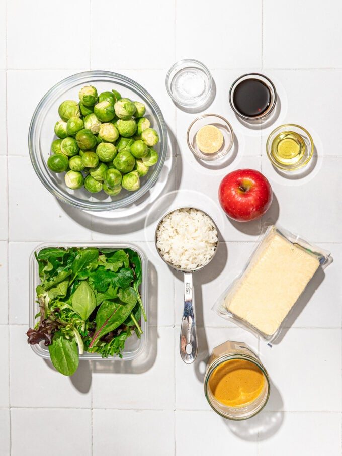 Brussels sprouts, tofu, rice and apple in bowls