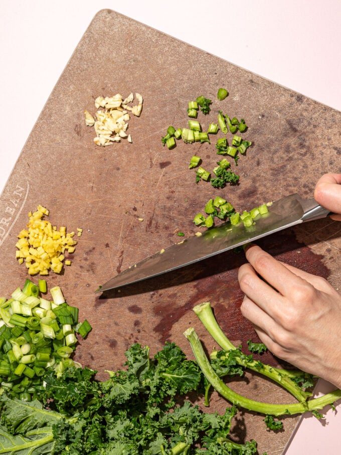 hand chopping kale stems