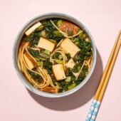 vegan ramen with kale and tofu in bowl with wooden chopsticks