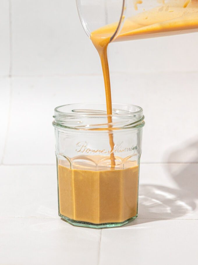 nutritional yeast dressing pouring into a jar