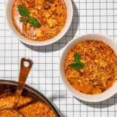 bowls of lasagna soup with pot and ladle