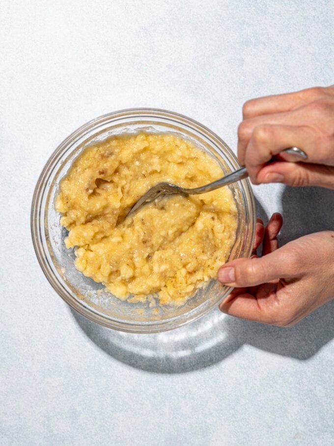 hand mashing banana