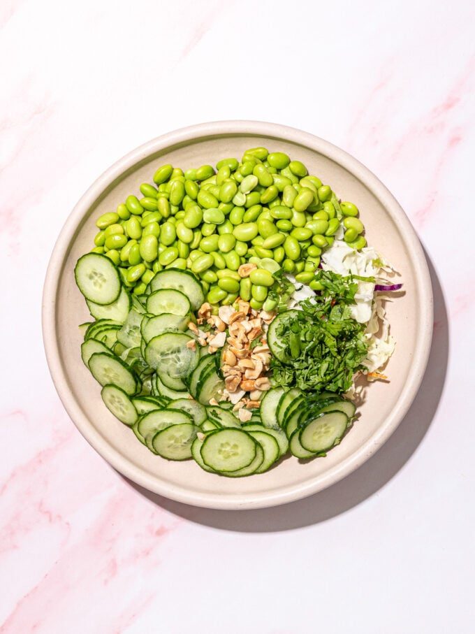 edamame, cucumber, peanuts and cilantro in white bowl